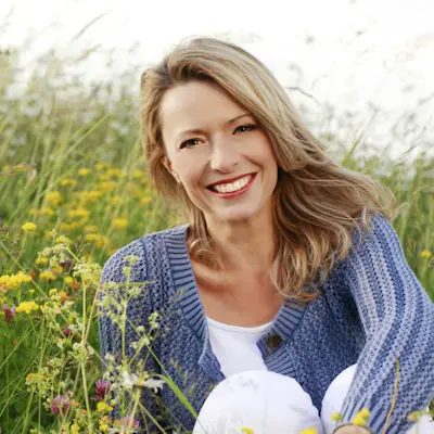 Woman in a field smiling