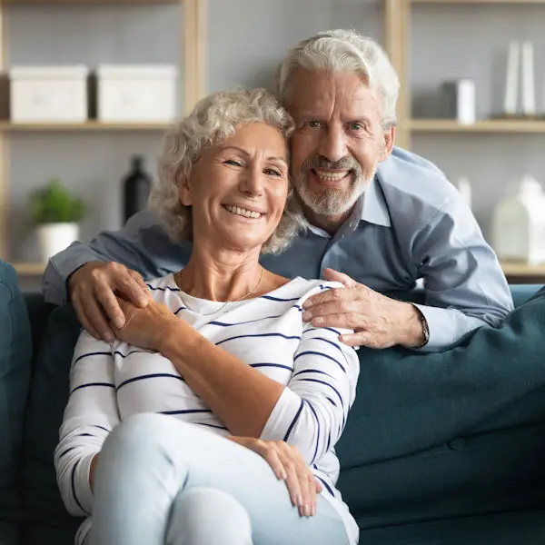 Get back to feeling good! Couple on a sofa smiling