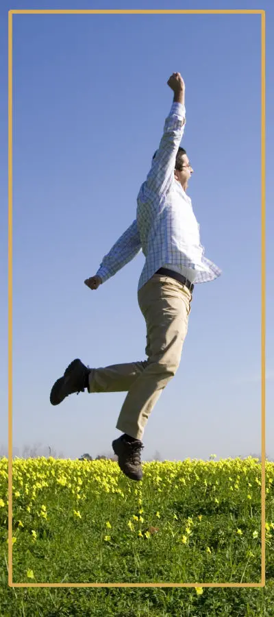 Get your life back! Man jumping in a field